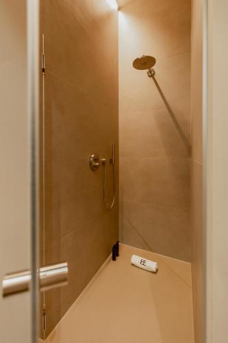 a bathroom with a shower with a scale on the floor at BTFL Living Antwerp in Antwerp