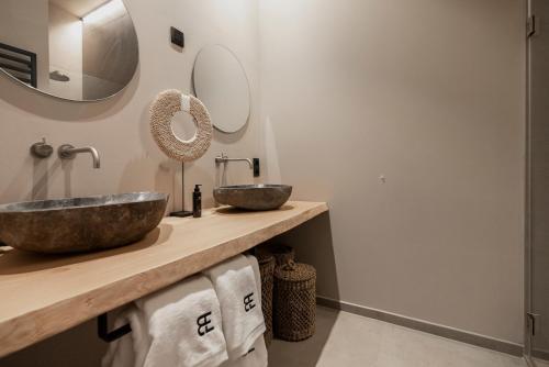 a bathroom with two sinks and two mirrors at BTFL Living Antwerp in Antwerp