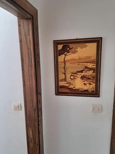 a picture hanging on a wall next to a door at Chalet Villa de Luxe - Piscine in Dchar Aït Belkassem
