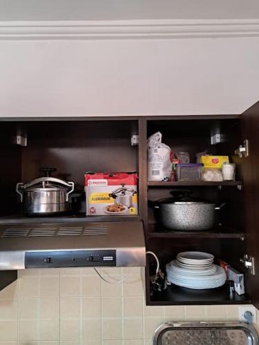 a kitchen with a stove top oven with dishes at Chalet Villa de Luxe - Piscine in Dchar Aït Belkassem