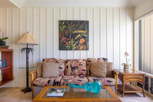 a living room with a couch and a table at Manualoha 303 in Koloa