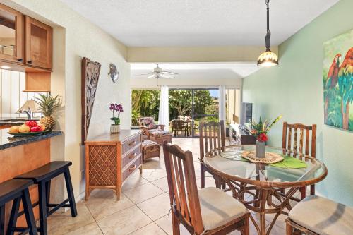 a kitchen and dining room with a table and chairs at Manualoha 303 in Koloa