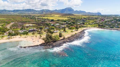 an aerial view of a beach with people and the ocean at Manualoha 303 in Koloa