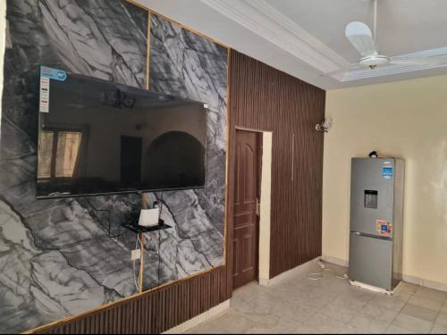 a wall with a flat screen tv on a wall at Villa Saran in Bamako