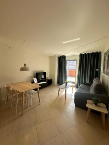 a living room with a couch and a table at AT home Avenida del Ejercito in Guadalajara