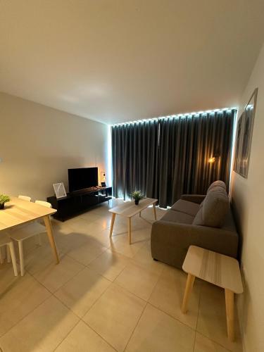 a living room with a couch and a table at AT home Avenida del Ejercito in Guadalajara