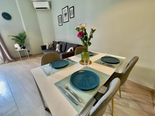 une table de salle à manger avec un vase de fleurs dessus dans l'établissement Cosy Home Cannes - Croisette, à Cannes