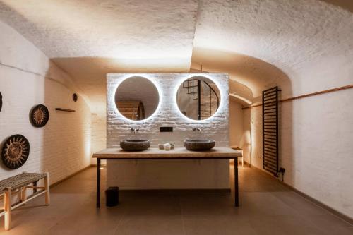 a bathroom with two sinks and two mirrors at BTFL Living Antwerp in Antwerp