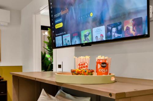 a table with a tray of food and a flat screen tv at Eugene Evergreen Escape By Leschaletsstays in Eugene