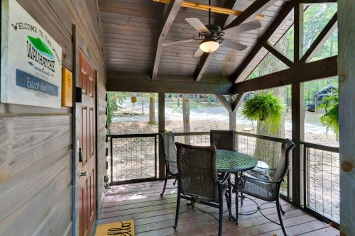 a screened in porch with a table and chairs at Pops Cabin Lookout Mountain Luxury Tiny Home in Chattanooga