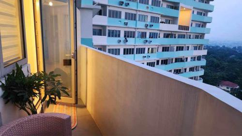 a balcony of a building with a table and a chair at Casa de Teresa in Manila