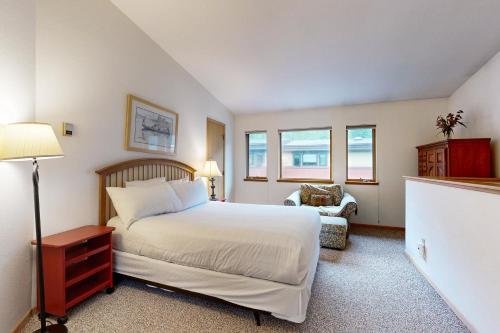 Un dormitorio con una gran cama blanca y una silla. en Meadow Creek L-5, en Vail