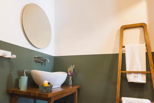 a bathroom with a sink and a mirror at A Soqquadro in Bisceglie