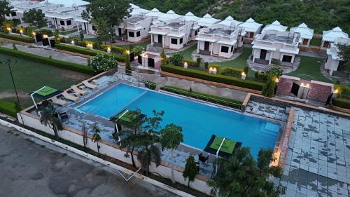 an aerial view of a large house with a swimming pool at The Sky Imperial Nakoda Green Valley Resort in Nāthdwāra