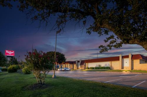 a parking lot in front of a motel at Red Roof Inn & Conference Center McKinney in McKinney