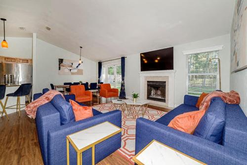 a living room with two blue couches and a fireplace at Family friendly - Fire pit -4 min to UF - Spacious in Gainesville