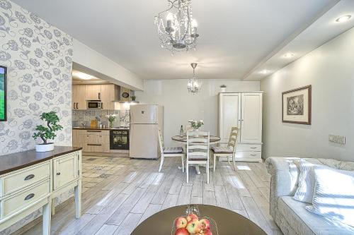 a kitchen and living room with a table and a couch at Elegant apartment in Old town Vilnius SELF CHECK IN 24x7 by H&H in Vilnius
