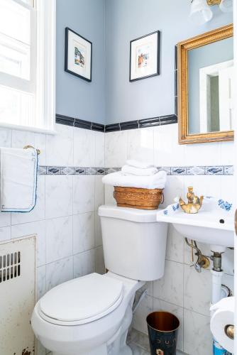 a bathroom with a white toilet and a sink at Cozy Homeva Battle Hill WP in White Plains
