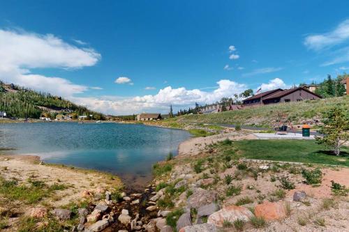 a body of water with houses in the background at Majestic Studio Pool-Spa Ski-in out Gym, Sauna, Laundry, BBQ in Brian Head