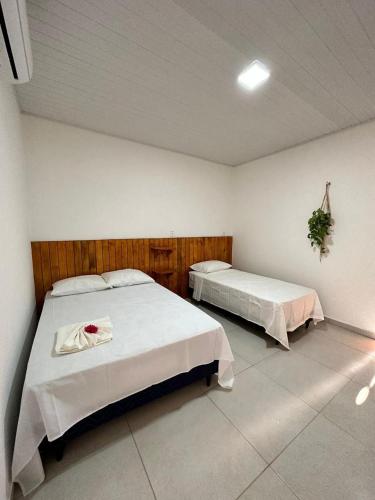 a bedroom with two beds in a room at Vento Leste Suites in Flecheiras