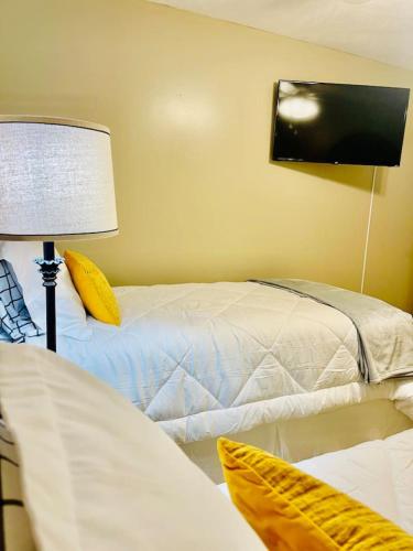 a bedroom with two beds and a tv on the wall at Eastgate 22A in Hammond
