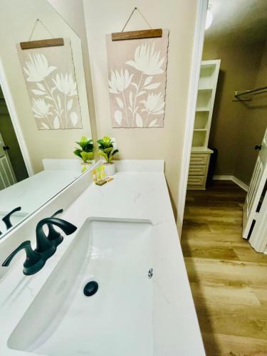 a white bathroom with a sink and a mirror at Eastgate 22A in Hammond