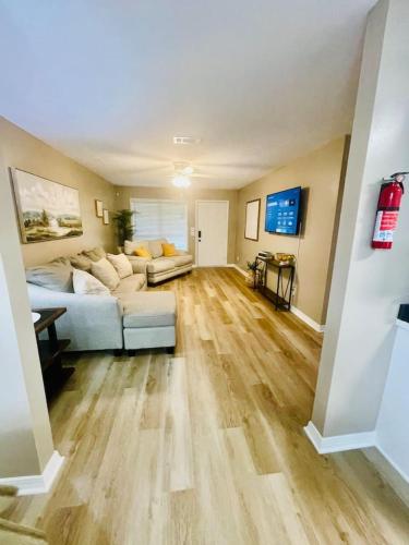 a living room with a white couch and wooden floors at Eastgate 22A in Hammond