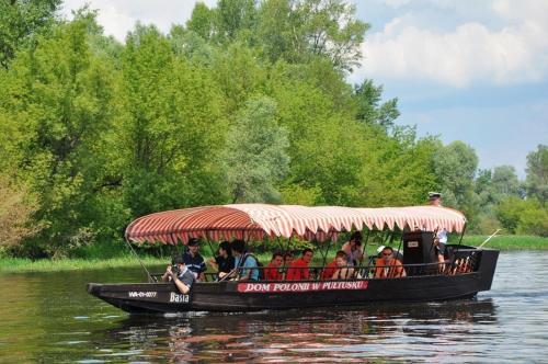 a group of people riding on a boat on the water at Hotel Zamek Pułtusk Dom Polonii in Pultusk