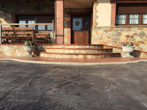 a building with a star on the ground in front at Apartamentos rurales la Aguilera in Oviñana