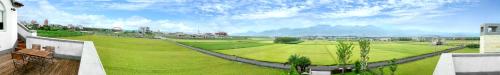 a rendering of a large green field with mountains in the background at Phil Garden Homestay in Dongshan