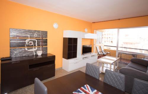 a living room with a couch and a television at Apartamento Babor Sun & Beach in Almerimar
