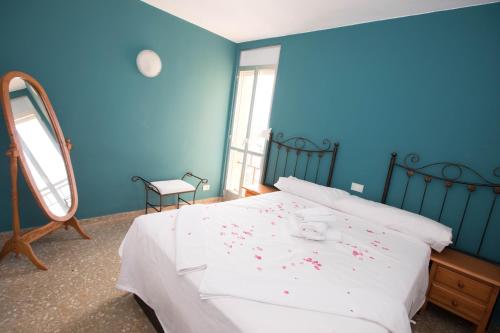 a bedroom with a bed with red confetti on it at Apartamento Babor Sun & Beach in Almerimar
