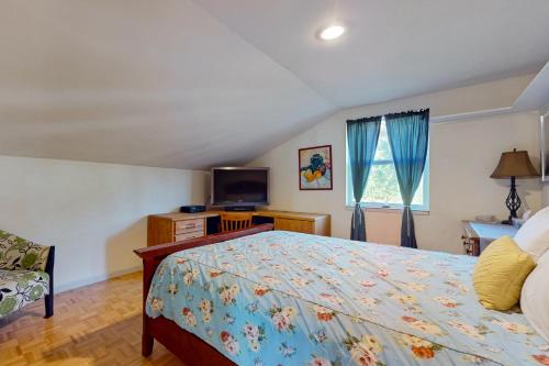 a bedroom with a bed and a tv in it at Palace Under the Pines in Bow