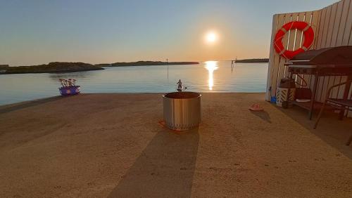 a trash can sitting on the beach near the water at Seaview apartment Karmøy in Sæveland