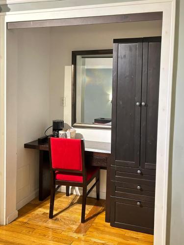 a red chair sitting at a desk with a mirror at Ponce De Leon Hotel in St Petersburg