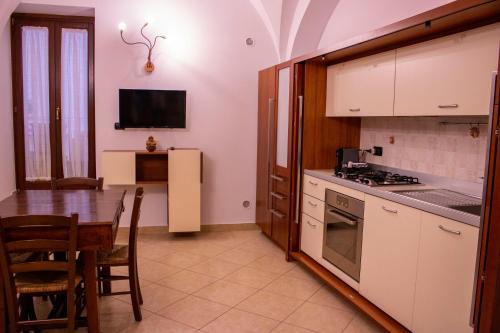 a kitchen with a table and a dining room at il Quadrifoglio in Putignano