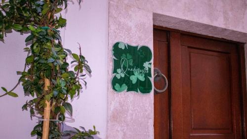 a sign on the side of a building next to a door at il Quadrifoglio in Putignano