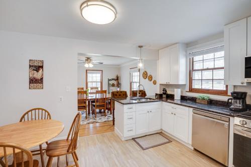 a kitchen with white cabinets and a table and a dining room at Spacious Minneapolis Home Rental 8 Mi to Downtown in Minneapolis