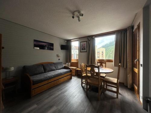 un salon avec un canapé et une table dans l'établissement Résidence Les Glaciers 3 - Studio pour 4 Personnes 23, à Mâcot La Plagne