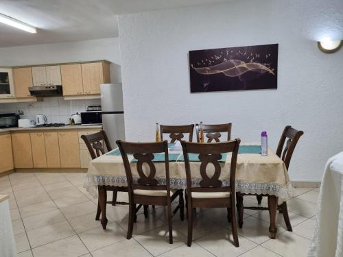 a dining room table and chairs in a kitchen at Beach Bliss in Flic-en-Flac