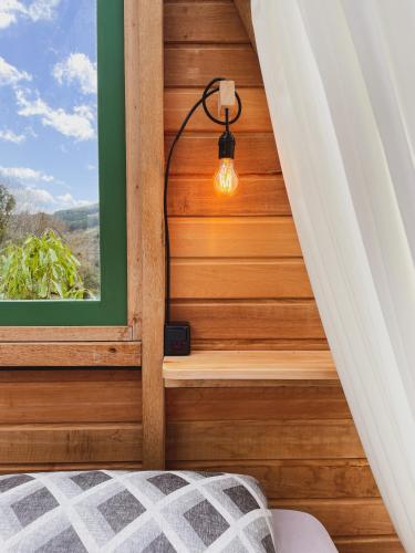 a bedroom with a stairway with a window at Morada do Guardião - Soldados Sebold in Barracão