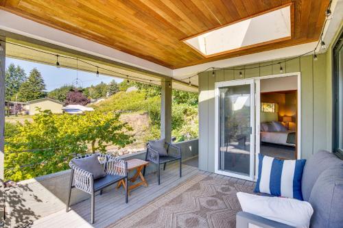 a patio with a couch and chairs on a porch at Gig Harbor Home Large Deck, Outdoor Dining Area in Gig Harbor