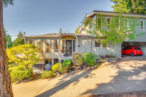 a house with a car parked in front of it at Gig Harbor Home Large Deck, Outdoor Dining Area in Gig Harbor