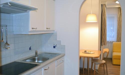 a kitchen with a sink and a small table at Apart Anna in Ischgl