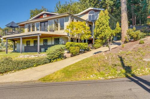 a house on a hill with a driveway at Gig Harbor Home Large Deck, Outdoor Dining Area in Gig Harbor