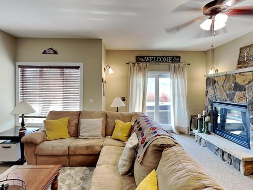 a living room with a couch and a tv at Lake House #9 in McHenry