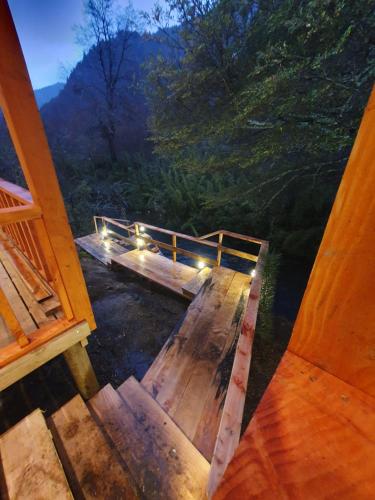 a view of a wooden deck with lights on it at Tiny & Big House Suite Los Mallines de Malalcahuello in Malalcahuello
