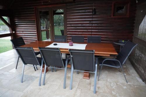 a wooden table and chairs on a patio at Dream Island House in Duga Resa
