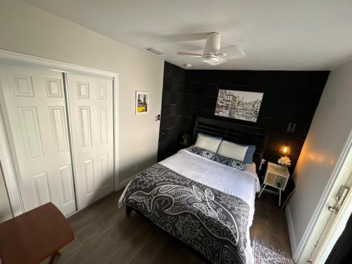 a bedroom with a bed with a black wall at Pura Vida Private Access, Room & Bathroom in West Palm Beach