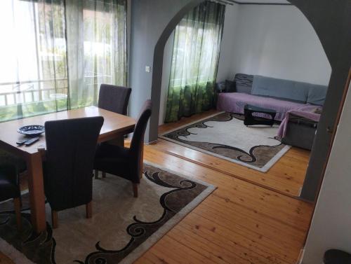 a living room with a table and a couch at Riki Apartments in Sarajevo